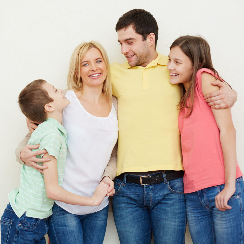 Portrait of affectionate family of four in isolation